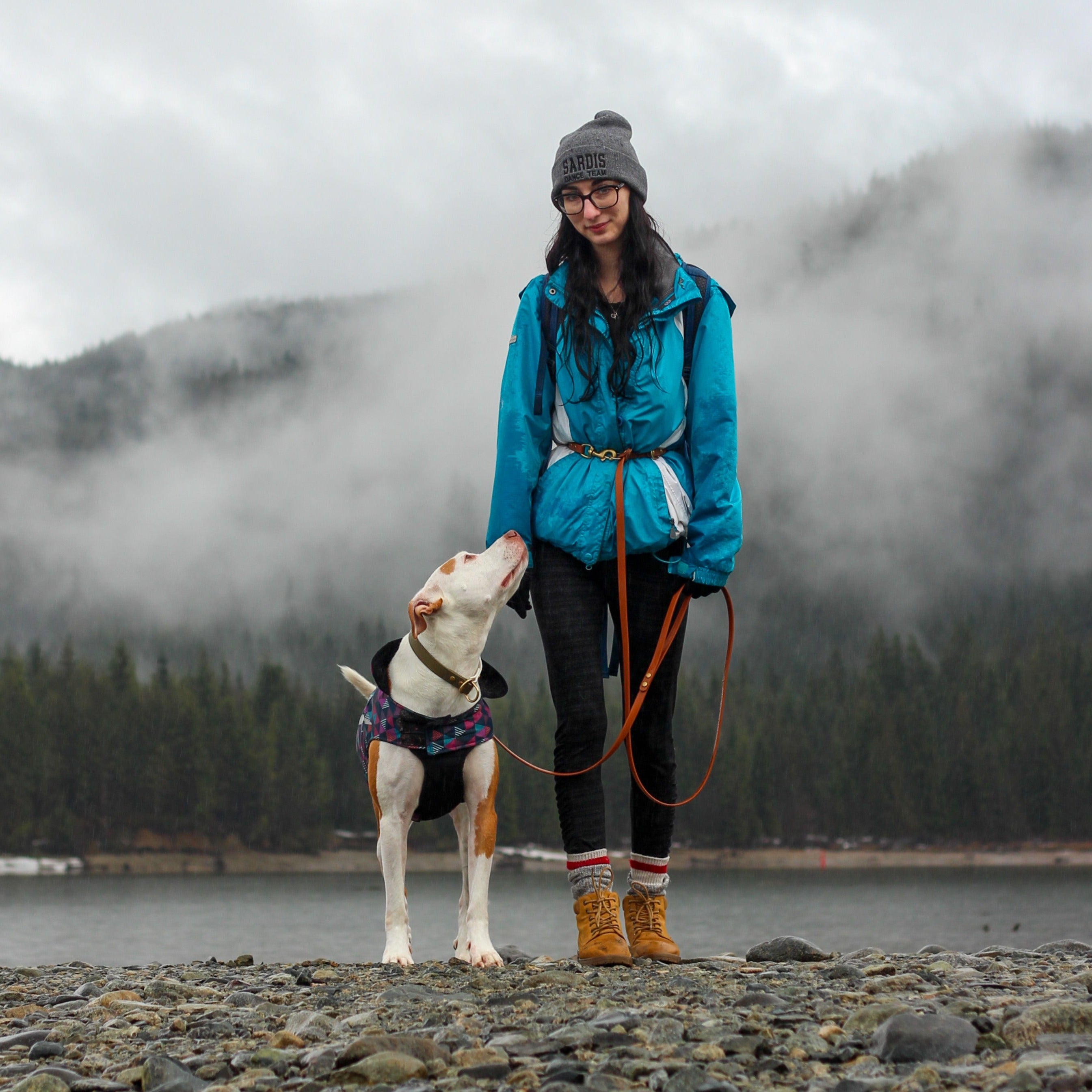 Woman and her Dog out exploring standing in front of some early morning fog over the lake wearing a 8' Hands-Free Biothane Dog Leash and Biothane Slip Collar